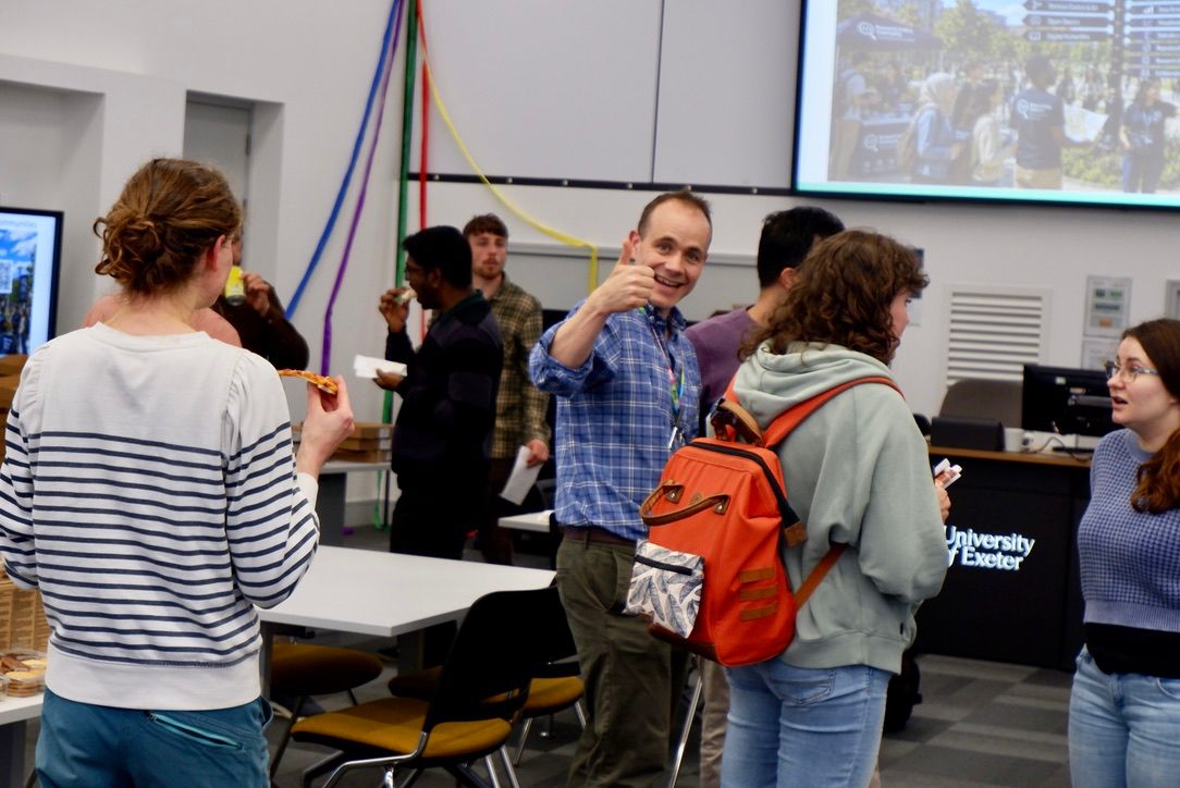 Research Coding Community Fair event photo showing attendees and activity in the room