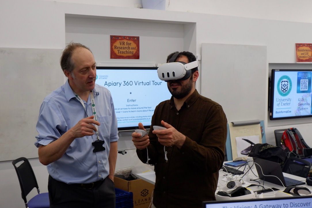 Research Coding Community Fair event photo showing stand holders and visitors